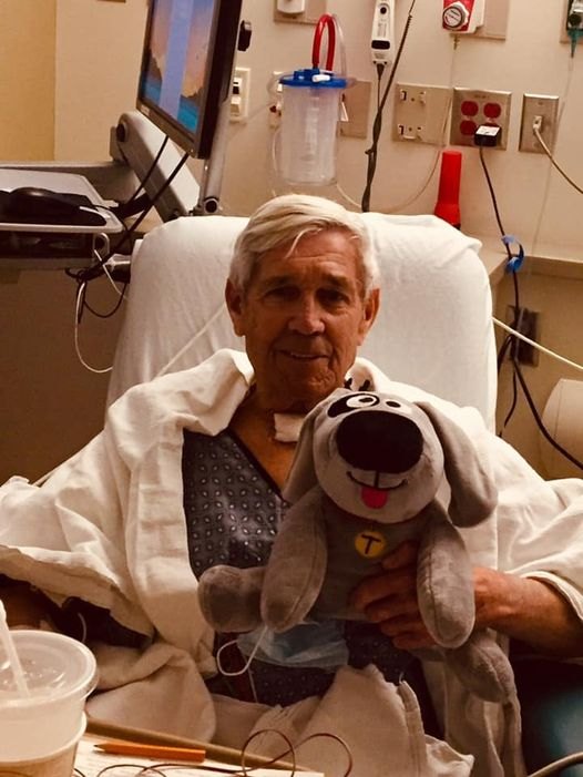 Eric holding Trouble the Dog during his hospital stay