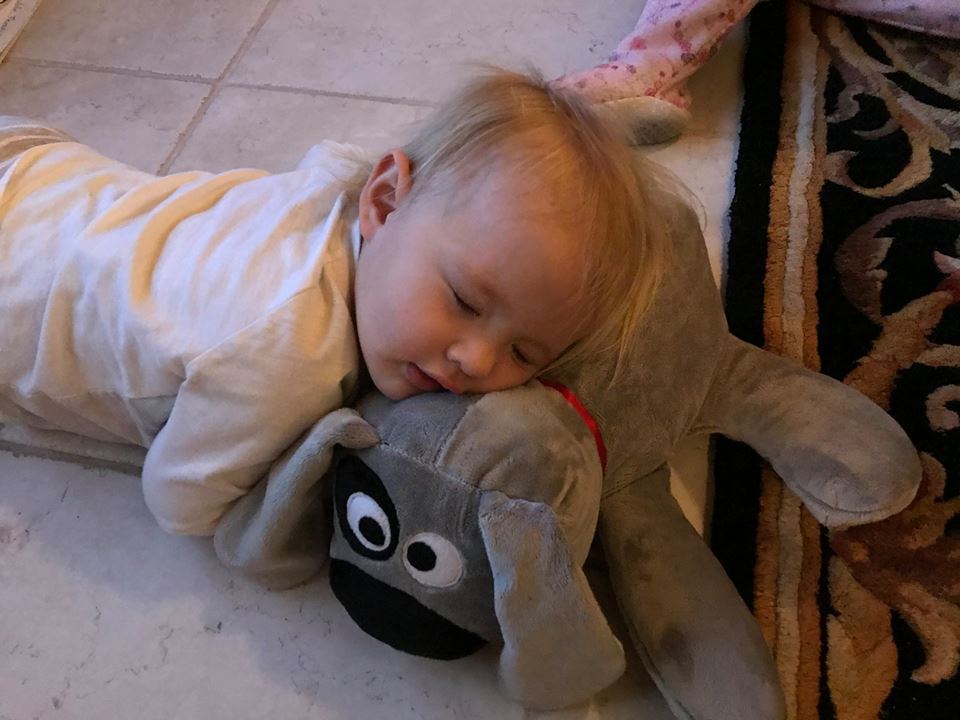 Ava sound asleep with Trouble the Dog