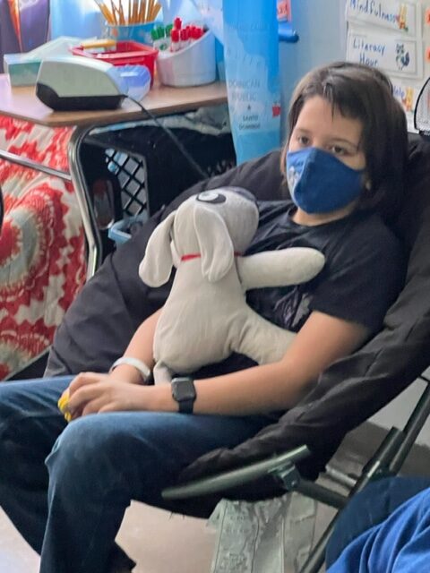 A child resting with Trouble on their chest